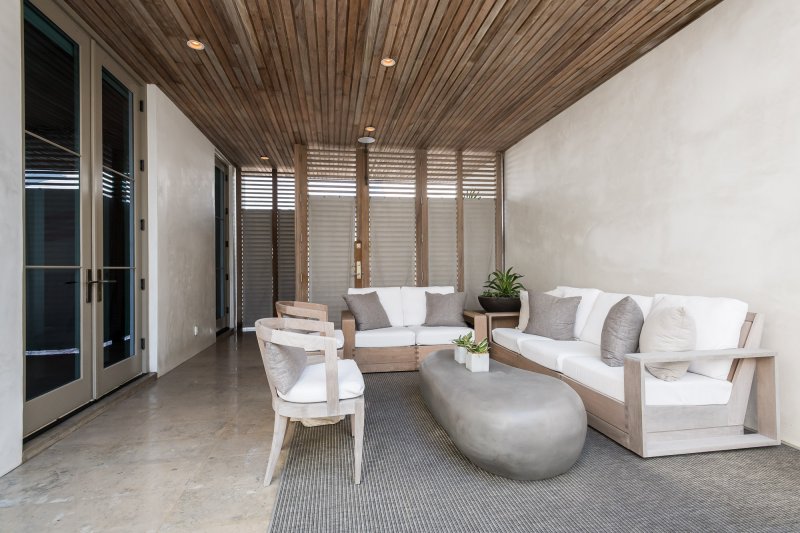 E.-F.-San-Juan-Alys-Beach-Custom-Courtyard custom wood facade, custom ceiling, courtyard design, alys beach florida, windows and doors, hurricane-rated millwork, satina hardwood design, khoury vogt architects, e f san juan