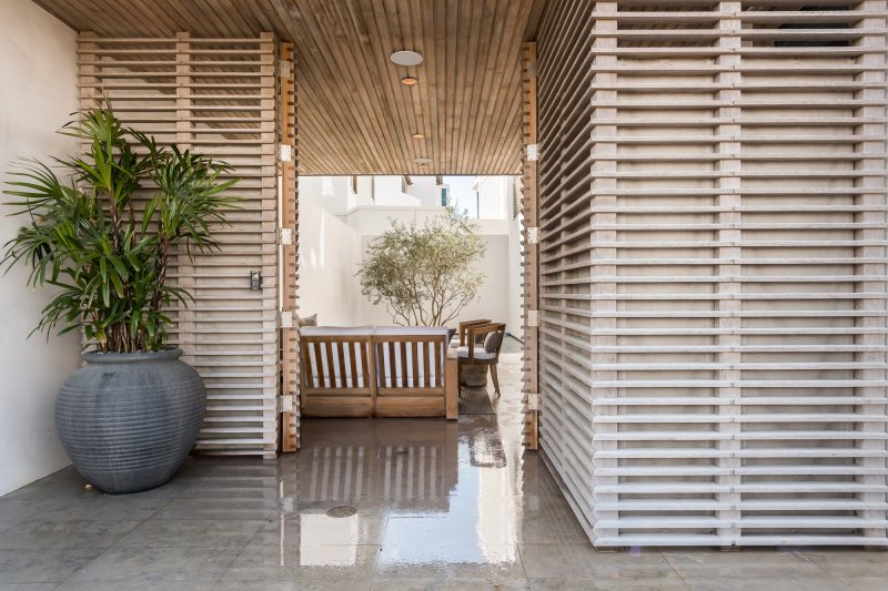 E.-F.-San-Juan-Alys-Beach-Custom-Hardwood-Screens custom wood facade, custom ceiling, courtyard design, alys beach florida, windows and doors, hurricane-rated millwork, satina hardwood design, khoury vogt architects, e f san juan
