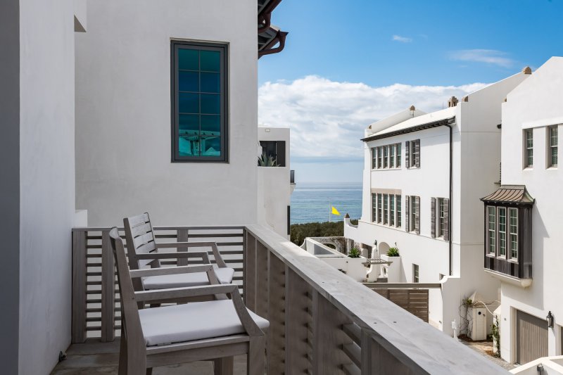 E.-F.-San-Juan-Alys-Beach-Custom-Wood-Balcony-Railings custom railings, custom wood facade, custom ceiling, courtyard design, alys beach florida, windows and doors, hurricane-rated millwork, satina hardwood design, khoury vogt architects, e f san juan