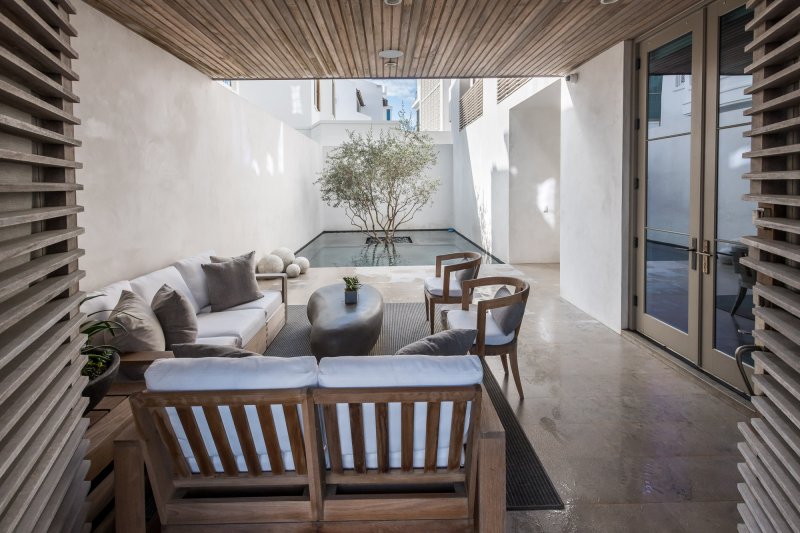 E.-F.-San-Juan-Alys-Beach-Custom-Wood-Railings custom wood facade, custom ceiling, courtyard design, alys beach florida, windows and doors, hurricane-rated millwork, satina hardwood design, khoury vogt architects, e f san juan