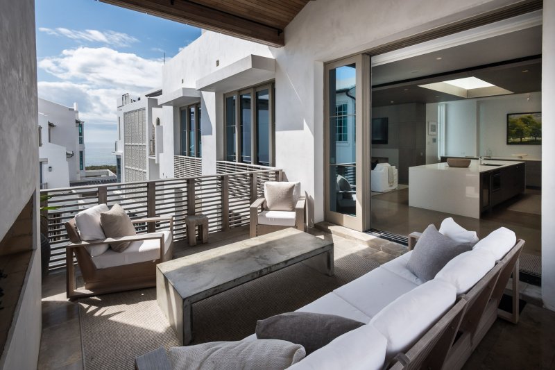 E.-F.-San-Juan-Alys-Beach-Florida-Custom-Balcony-Patio custom railings, custom wood facade, custom ceiling, courtyard design, alys beach florida, windows and doors, hurricane-rated millwork, satina hardwood design, khoury vogt architects, e f san juan